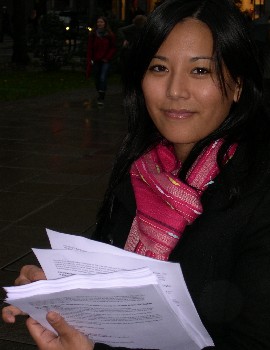 Dechen Pelmo Thargyal giving handouts to passers-by 350 2.jpg