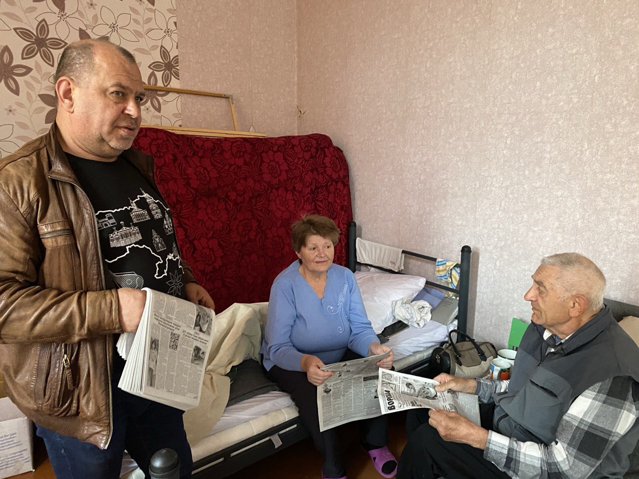 Pictured: Oleksii Pasiuha, Chief Editor of Vorskla, distributing the newspaper to internally displaced persons at an emergency shelter set up in a school in Okhtyrka, Sumy Oblast, Ukraine, in April–May 2024. 